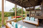 Lower deck with bench swing, lounge seating and twinkle lights